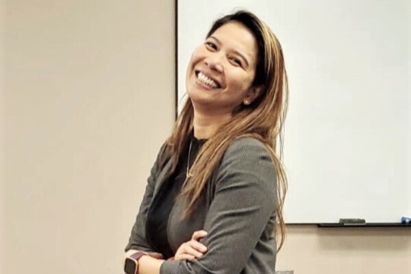 image of Marvita smiling in front of a whiteboard