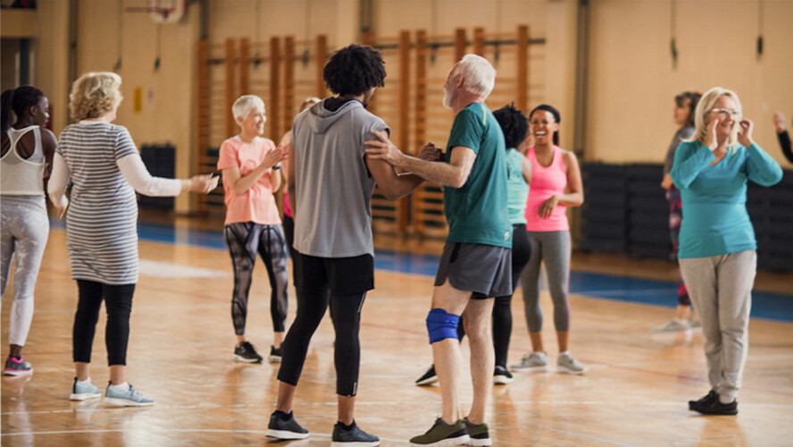 Group of adults participate in exercise class